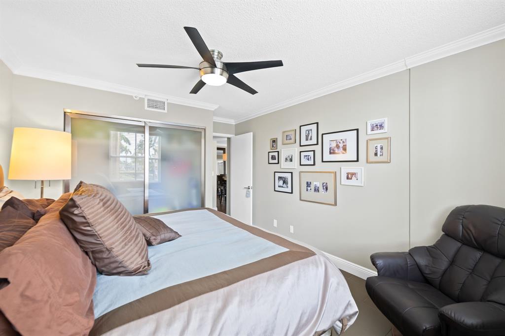 1341 Southeast 3rd Avenue, Unit 206 Dania Beach, FL 33004 - Photo 11 of 20 a bedroom with a large bed and a couch