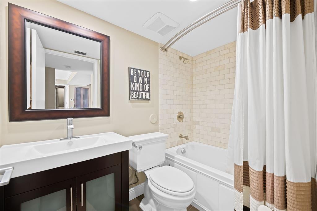 1341 Southeast 3rd Avenue, Unit 206 Dania Beach, FL 33004 - Photo 17 of 20 a bathroom with a toilet a sink a mirror a vanity and shower