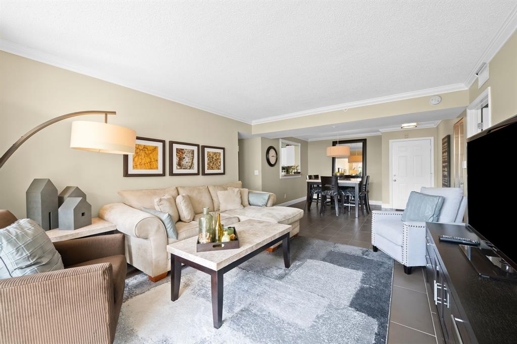 1341 Southeast 3rd Avenue, Unit 206 Dania Beach, FL 33004 - Photo 2 of 20 a living room with furniture and a flat screen tv