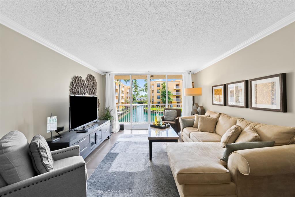 1341 Southeast 3rd Avenue, Unit 206 Dania Beach, FL 33004 - Photo 4 of 20 a living room with furniture and a flat screen tv