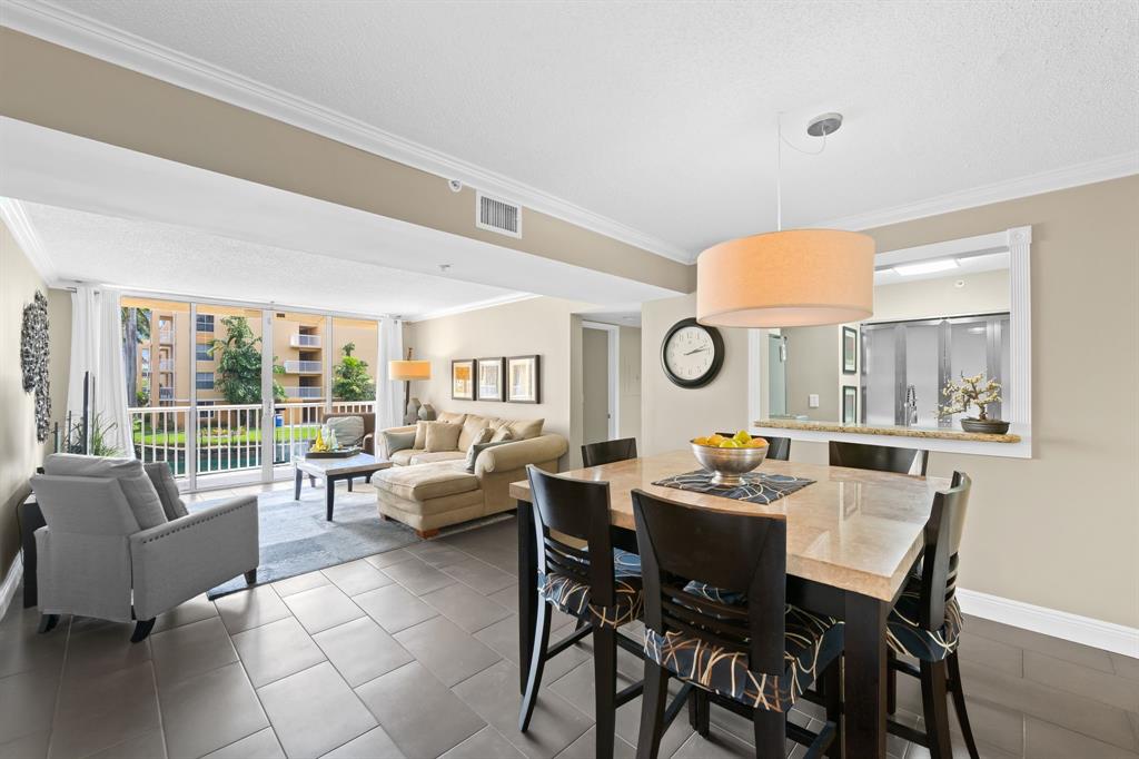 1341 Southeast 3rd Avenue, Unit 206 Dania Beach, FL 33004 - Photo 5 of 20 a dining room with furniture and a large window
