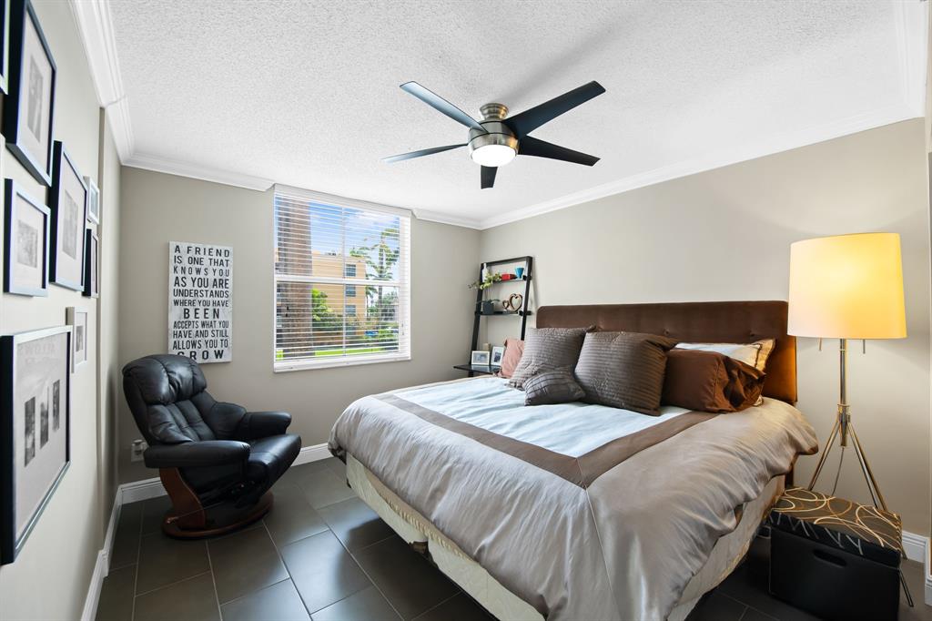 1341 Southeast 3rd Avenue, Unit 206 Dania Beach, FL 33004 - Photo 10 of 20 a bedroom with a bed and a couch