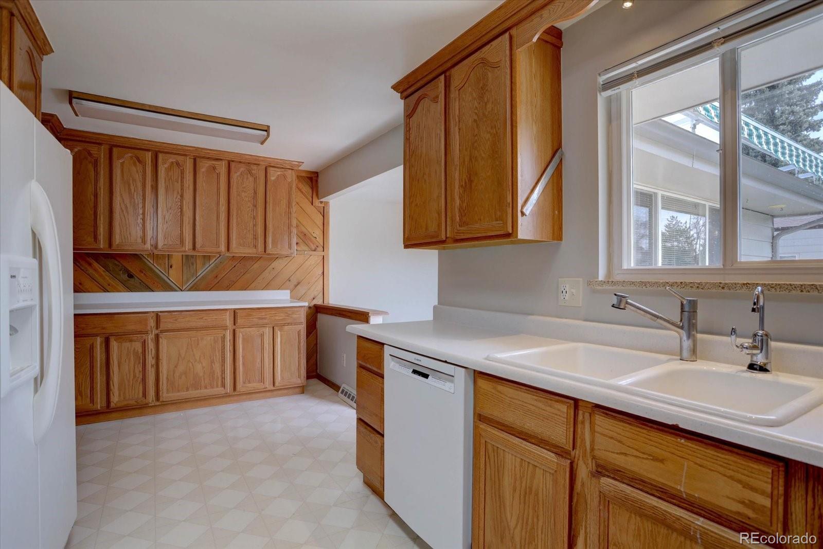 6272 South Garfield Drive Centennial, CO 80121 - Photo 10 of 37 a kitchen with a sink cabinets and window