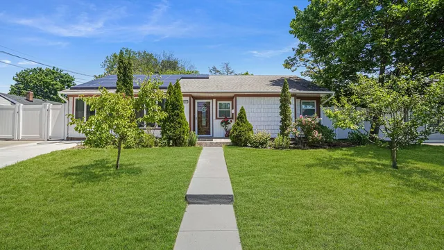 a front view of house with yard and green space
