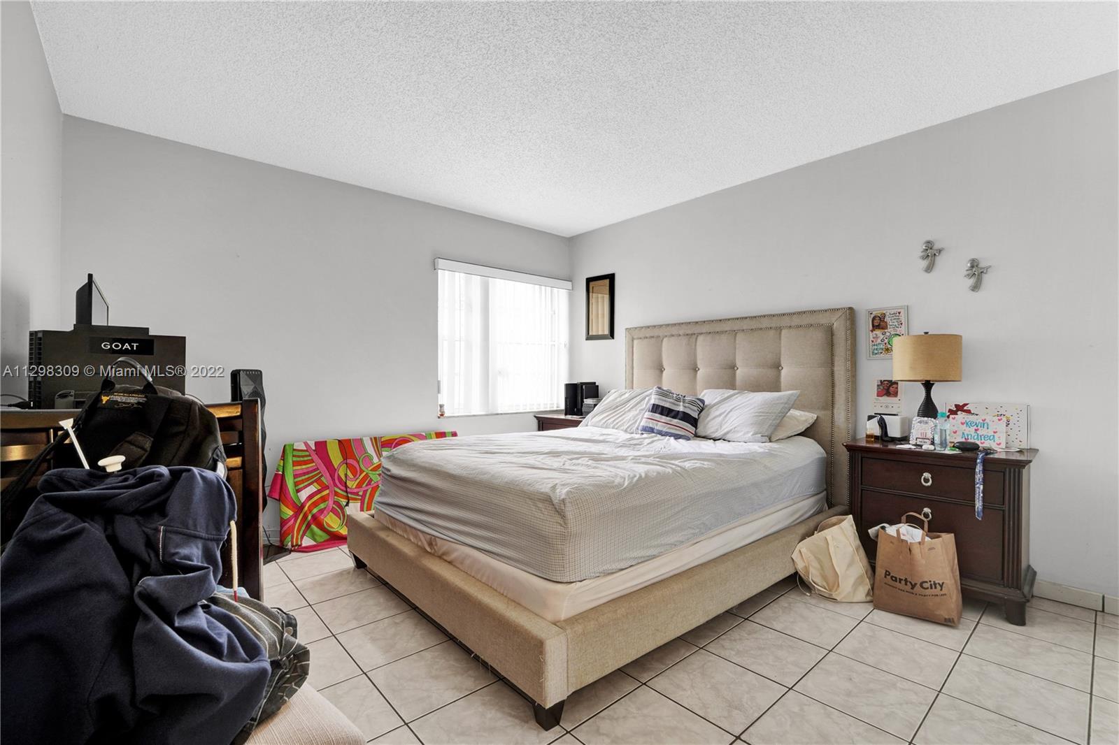 9331 Southwest 4th Street, Unit 118B Miami, FL 33174 - Photo 14 of 16 a bedroom with a bed and dresser