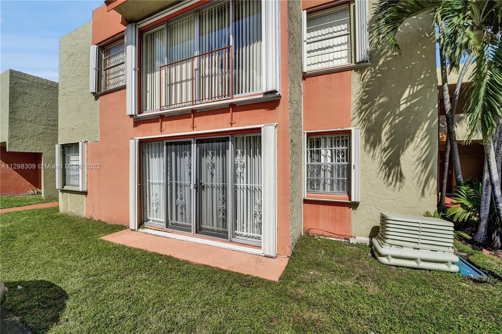9331 Southwest 4th Street, Unit 118B Miami, FL 33174 - Photo 15 of 16 a view of a house with backyard and porch