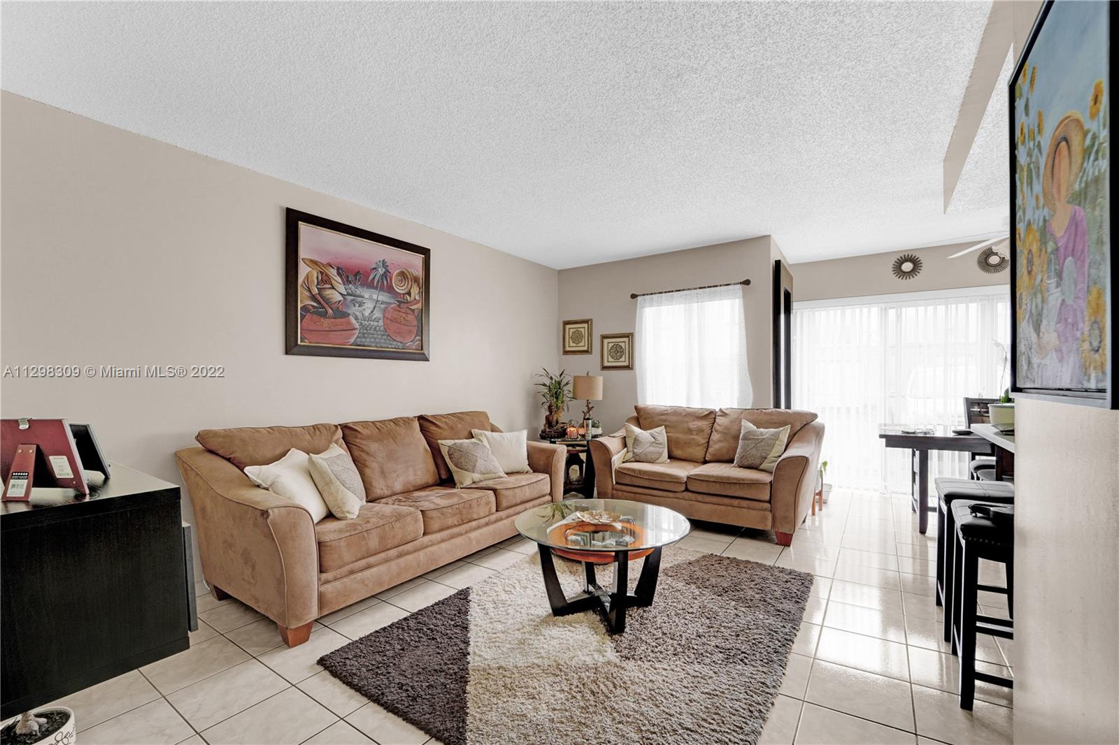 9331 Southwest 4th Street, Unit 118B Miami, FL 33174 - Photo 4 of 16 a living room with furniture a rug and a window