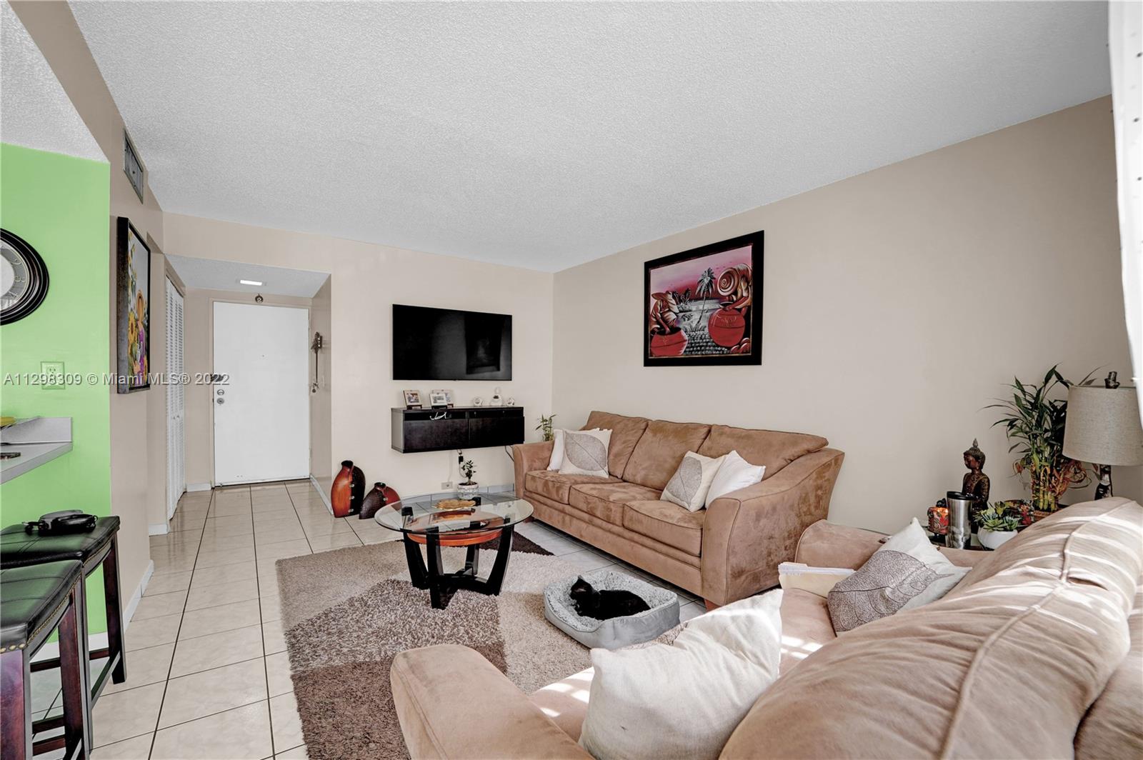 9331 Southwest 4th Street, Unit 118B Miami, FL 33174 - Photo 5 of 16 a living room with furniture and a flat screen tv