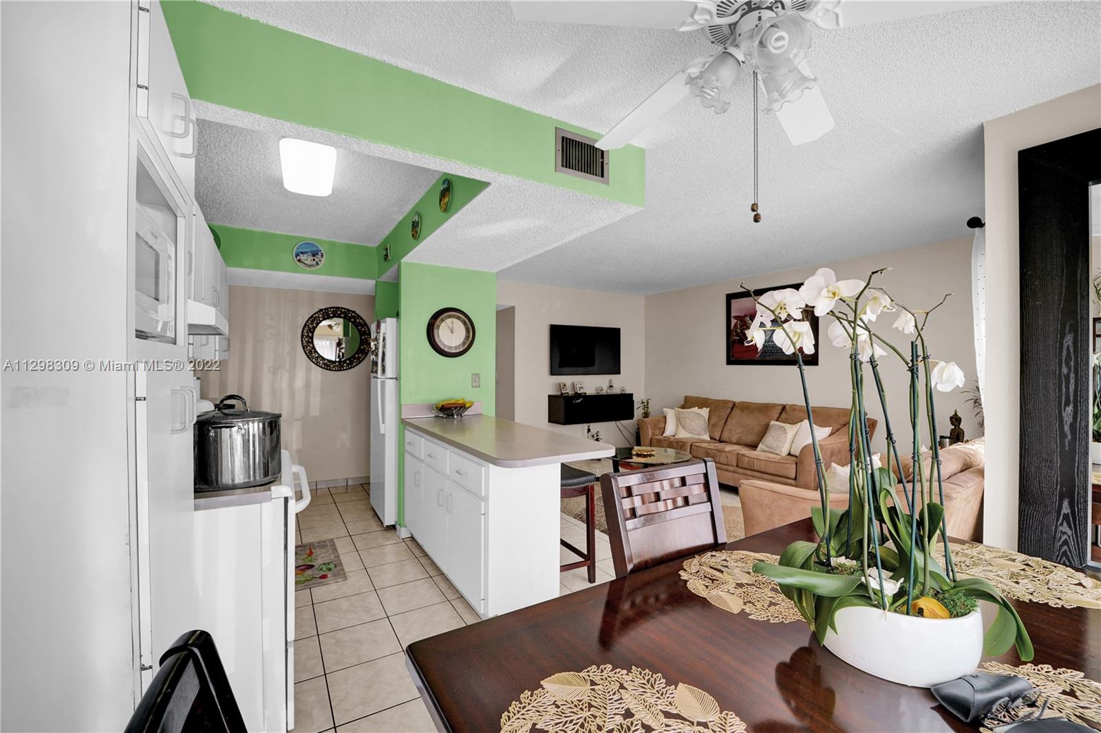 9331 Southwest 4th Street, Unit 118B Miami, FL 33174 - Photo 6 of 16 a living room with furniture and a large window