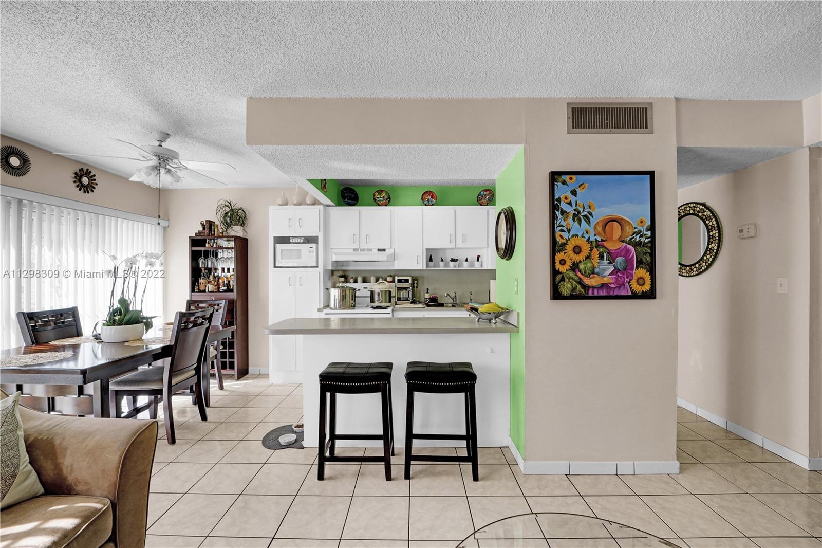 9331 Southwest 4th Street, Unit 118B Miami, FL 33174 - Photo 7 of 16 a kitchen with stainless steel appliances granite countertop a refrigerator and a stove top oven