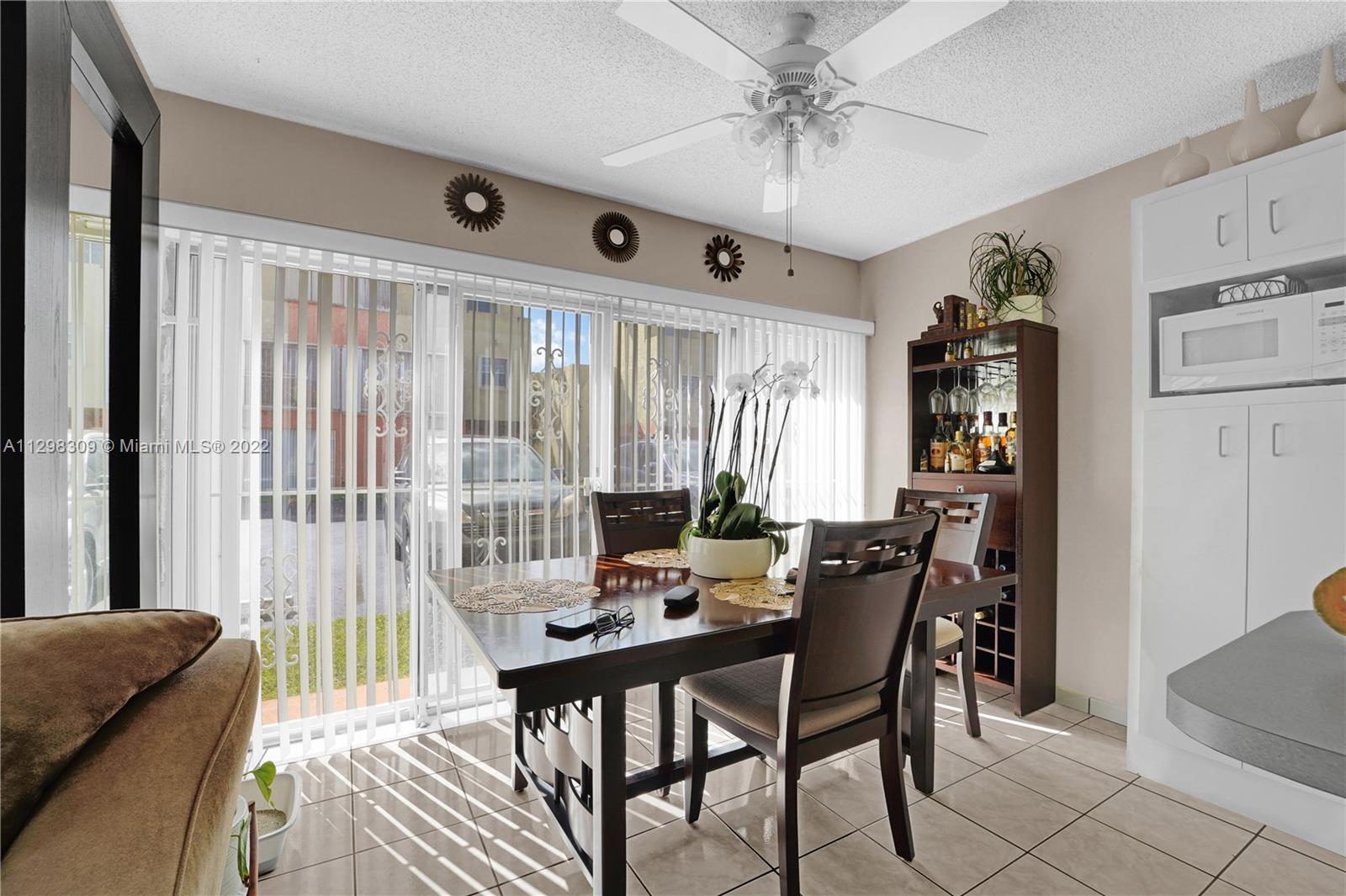 9331 Southwest 4th Street, Unit 118B Miami, FL 33174 - Photo 8 of 16 a view of a dining room with furniture window and outside view