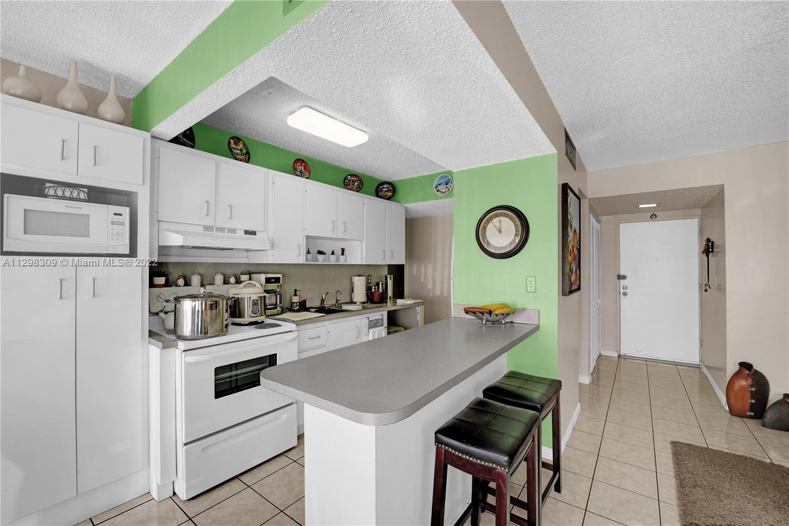 9331 Southwest 4th Street, Unit 118B Miami, FL 33174 - Photo 9 of 16 a kitchen with cabinets and stainless steel appliances