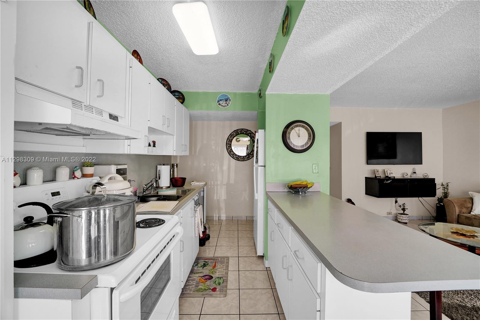 9331 Southwest 4th Street, Unit 118B Miami, FL 33174 - Photo 10 of 16 a kitchen with stainless steel appliances granite countertop a sink and a stove