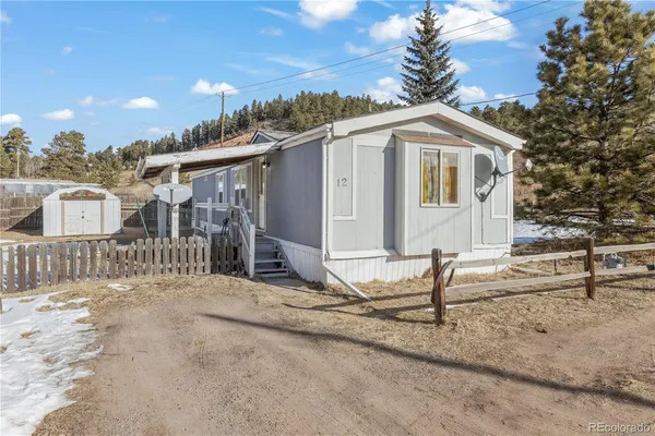 a view of a house with a wooden fence