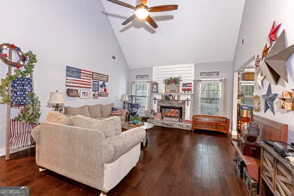 a living room with furniture wooden floor and a flat screen tv