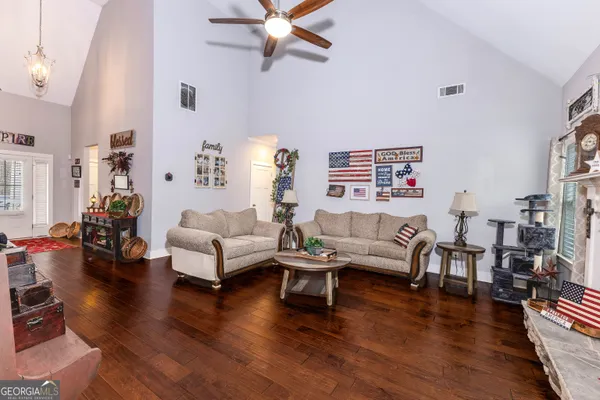 a living room with furniture and a wooden floor