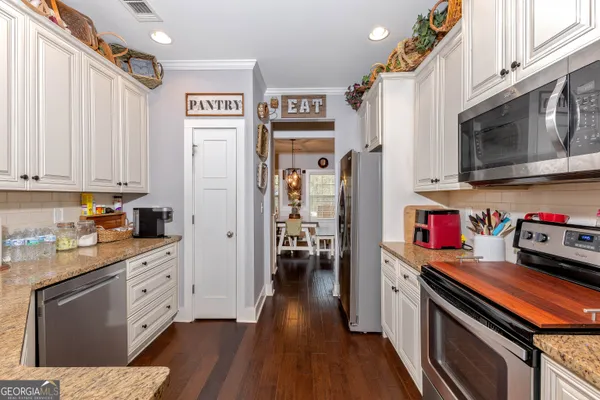 a kitchen with stainless steel appliances a stove top oven and a refrigerator