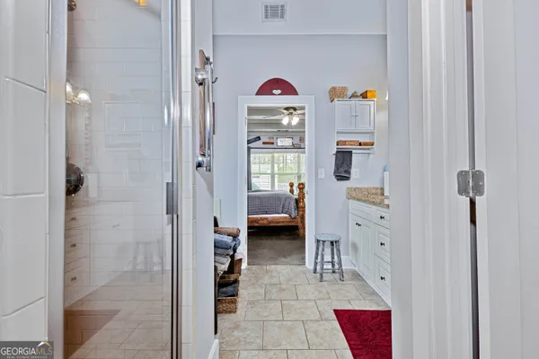 a hallway with cabinets and a living room
