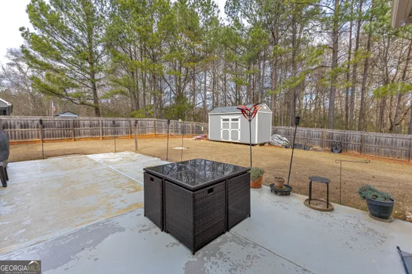 a view of a backyard with swimming pool