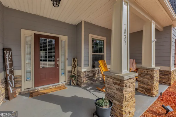 a front view of a house with outdoor seating