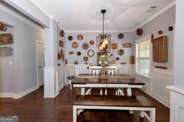 a view of a dining room with furniture and chandelier