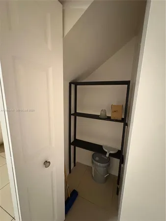 a room with a wooden floor and a potted plant on th wall