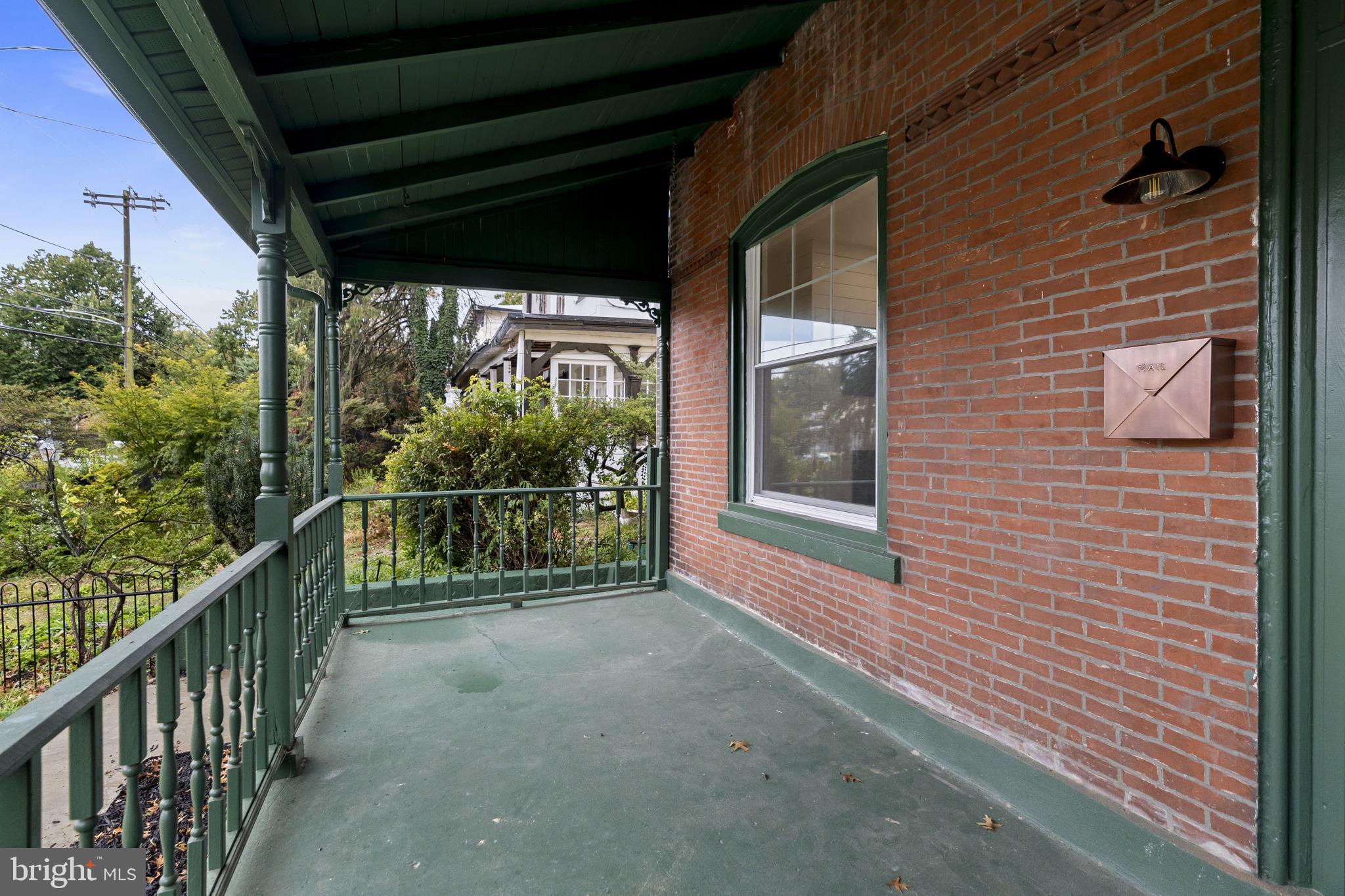 147 Harvey Street Philadelphia, PA 19144 - Photo 33 of 37 a view of a porch with a floor to ceiling window and potted plants