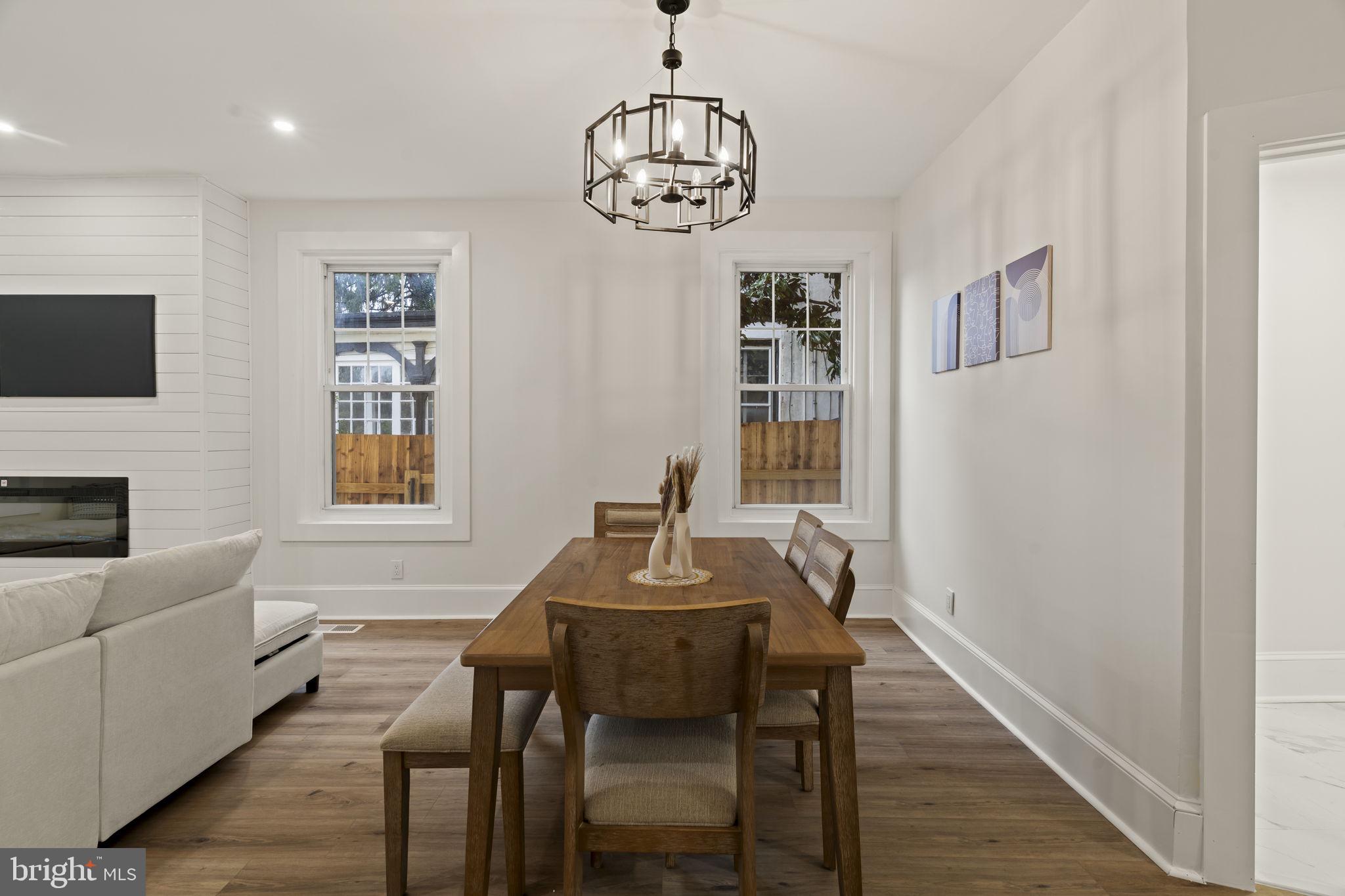 147 Harvey Street Philadelphia, PA 19144 - Photo 6 of 37 a dining room with furniture a chandelier and wooden floor