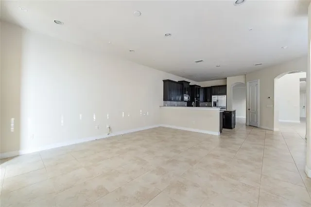 a view of a living room hardwood floor and a window