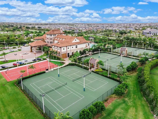 an aerial view of residential houses with outdoor space and trees