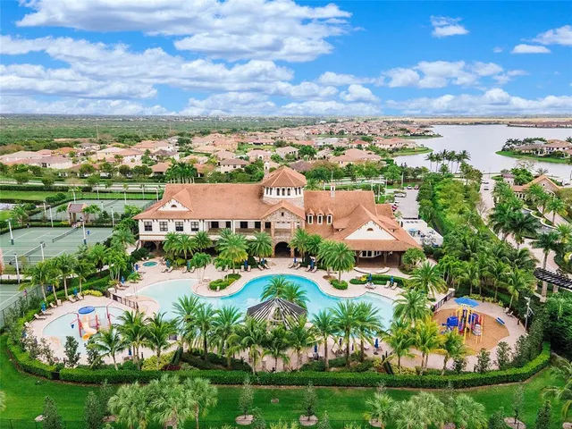 an aerial view of a house with outdoor space and swimming pool