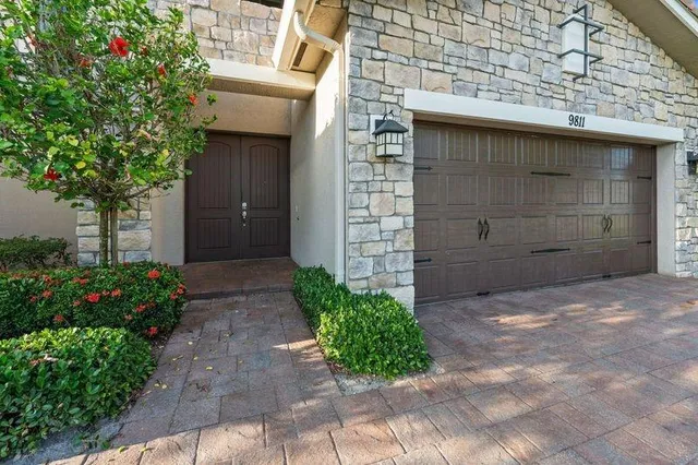 a front view of a house with a garden