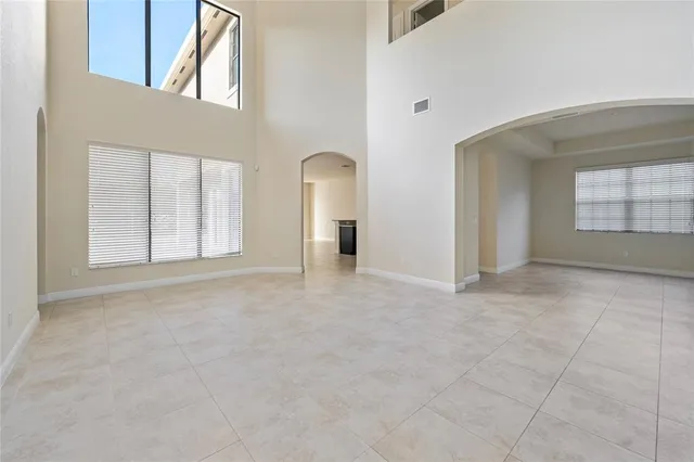 a view of a hallway with wooden floor and a living room