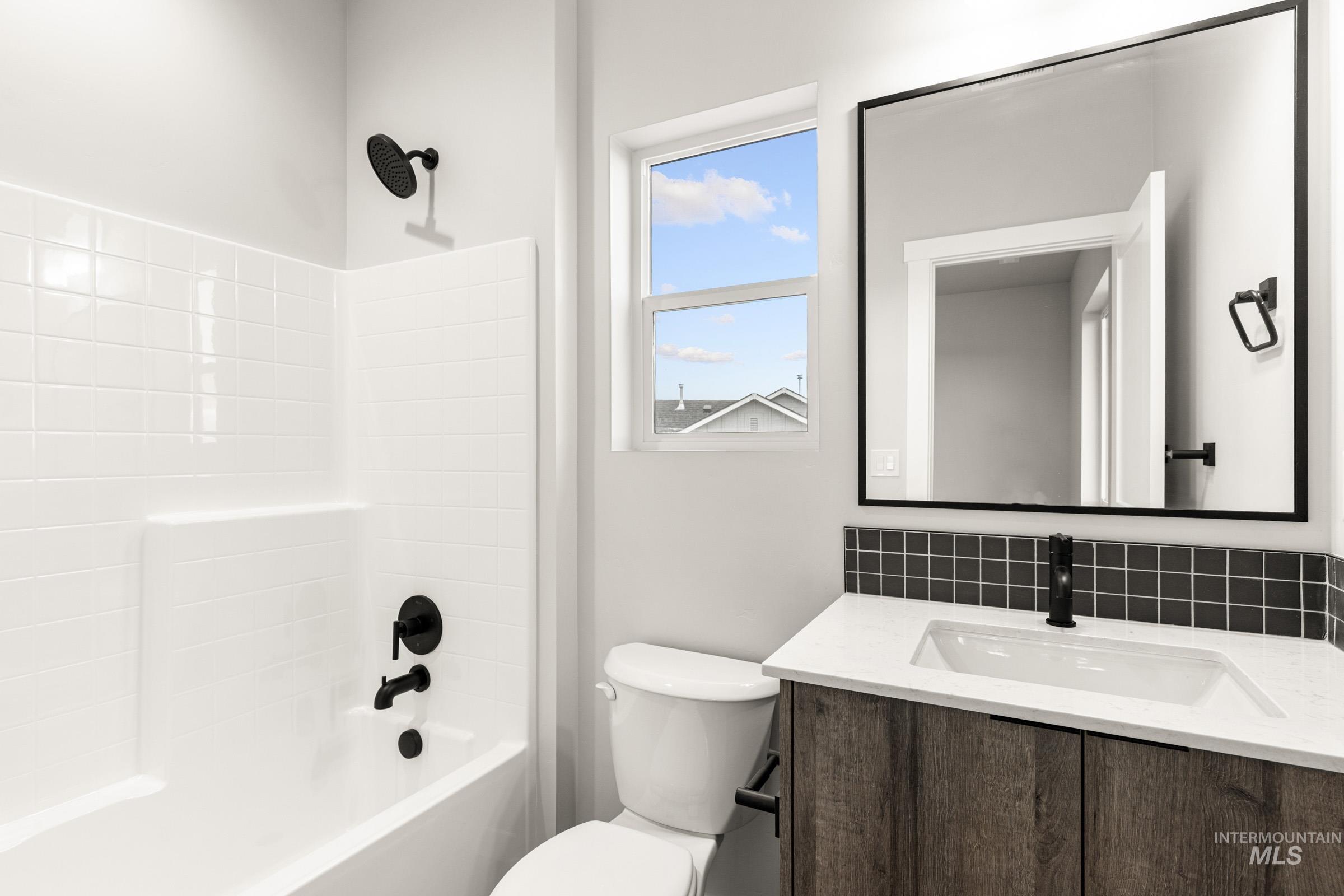 4227 East Rincon Drive Meridian, ID 83642 - Photo 21 of 31 Modern bathroom featuring a wood-finish vanity with a white countertop and integrated sink