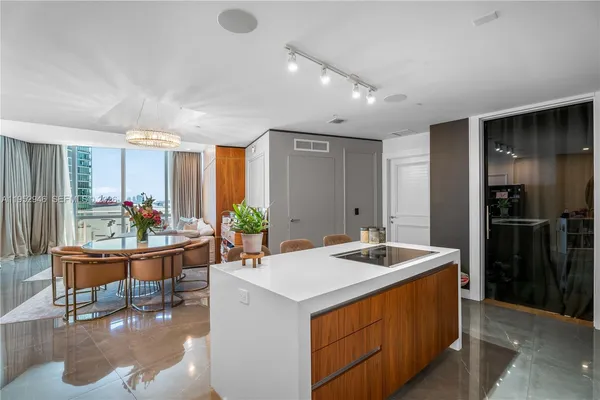 a kitchen with a sink refrigerator and cabinets