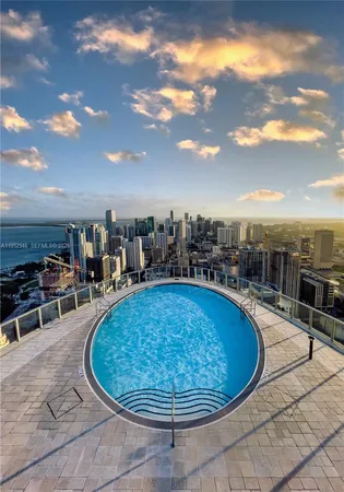 a view of a swimming pool with furniture