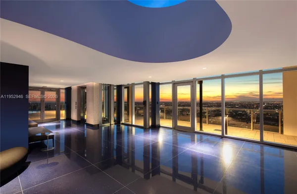 a lobby with furniture and floor to ceiling window
