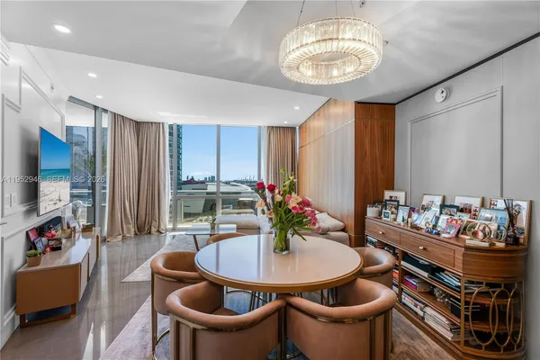 a dining room with furniture and a chandelier