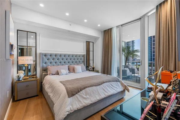 a bedroom with a bed and a large window