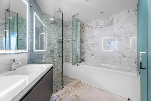 a bathroom with a bathtub and a sink
