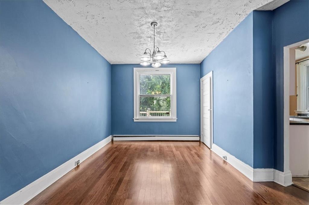 503 Marie Avenue Pittsburgh, PA 15202 - Photo 9 of 31 a view of a room with wooden floors and chandelier