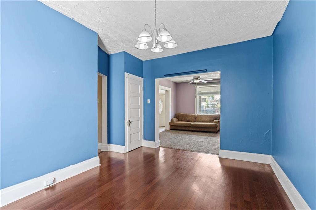 503 Marie Avenue Pittsburgh, PA 15202 - Photo 10 of 31 a view of a hallway with wooden floor and a chandelier