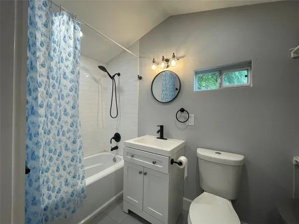 a bathroom with a toilet sink and shower