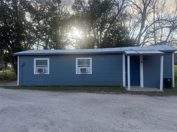 a view of a house with a large tree