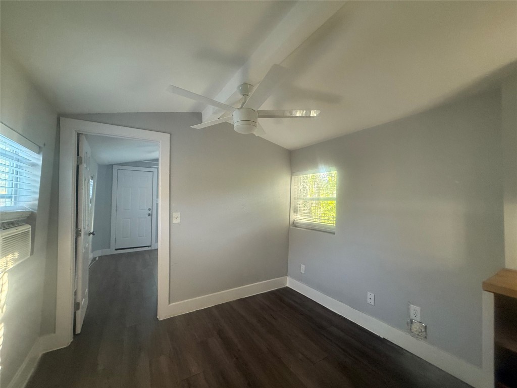 2113 River Road, Unit A San Marcos, TX 78666 - Photo 7 of 12 Empty room featuring dark wood finished floors, lofted ceiling, and ceiling fan