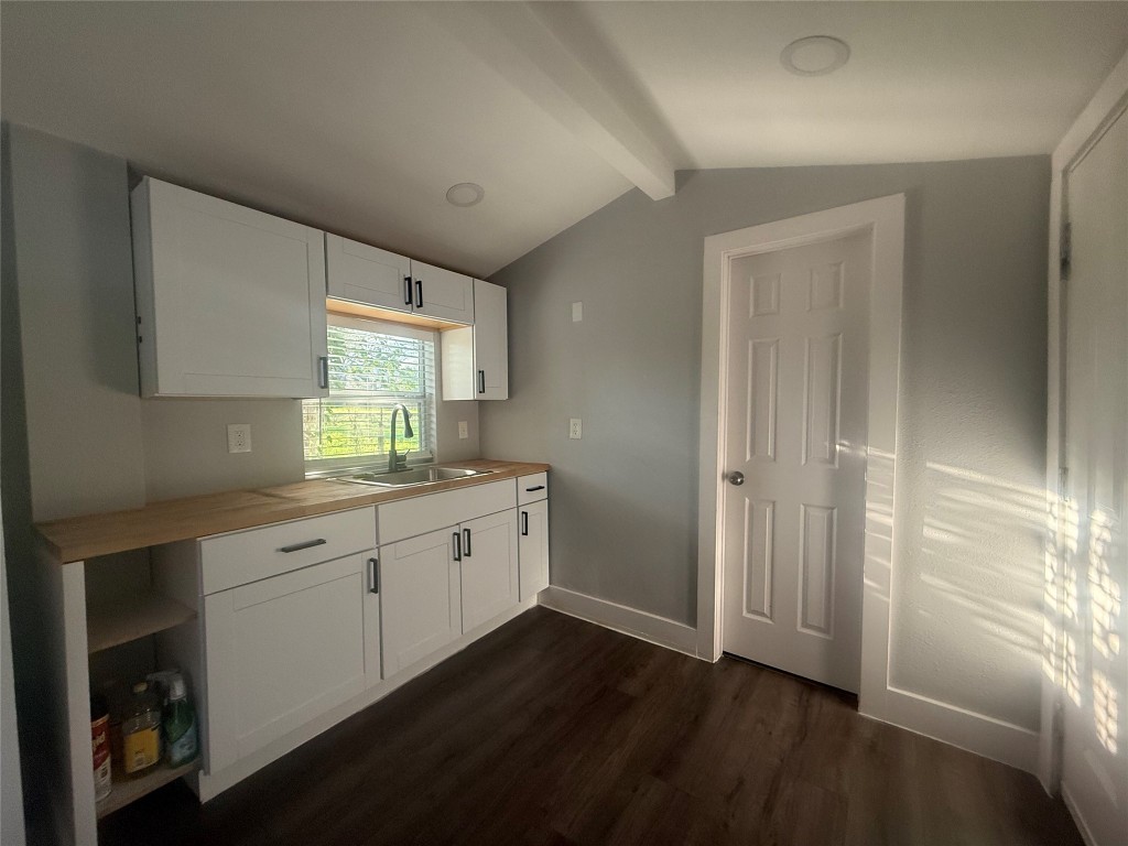 2113 River Road, Unit A San Marcos, TX 78666 - Photo 8 of 12 Kitchen featuring white cabinets, dark wood-style floors, and wood counters