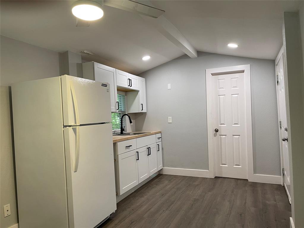 2113 River Road, Unit A San Marcos, TX 78666 - Photo 9 of 12 Kitchen with freestanding refrigerator, white cabinets, dark wood-style floors, light countertops, and recessed lighting