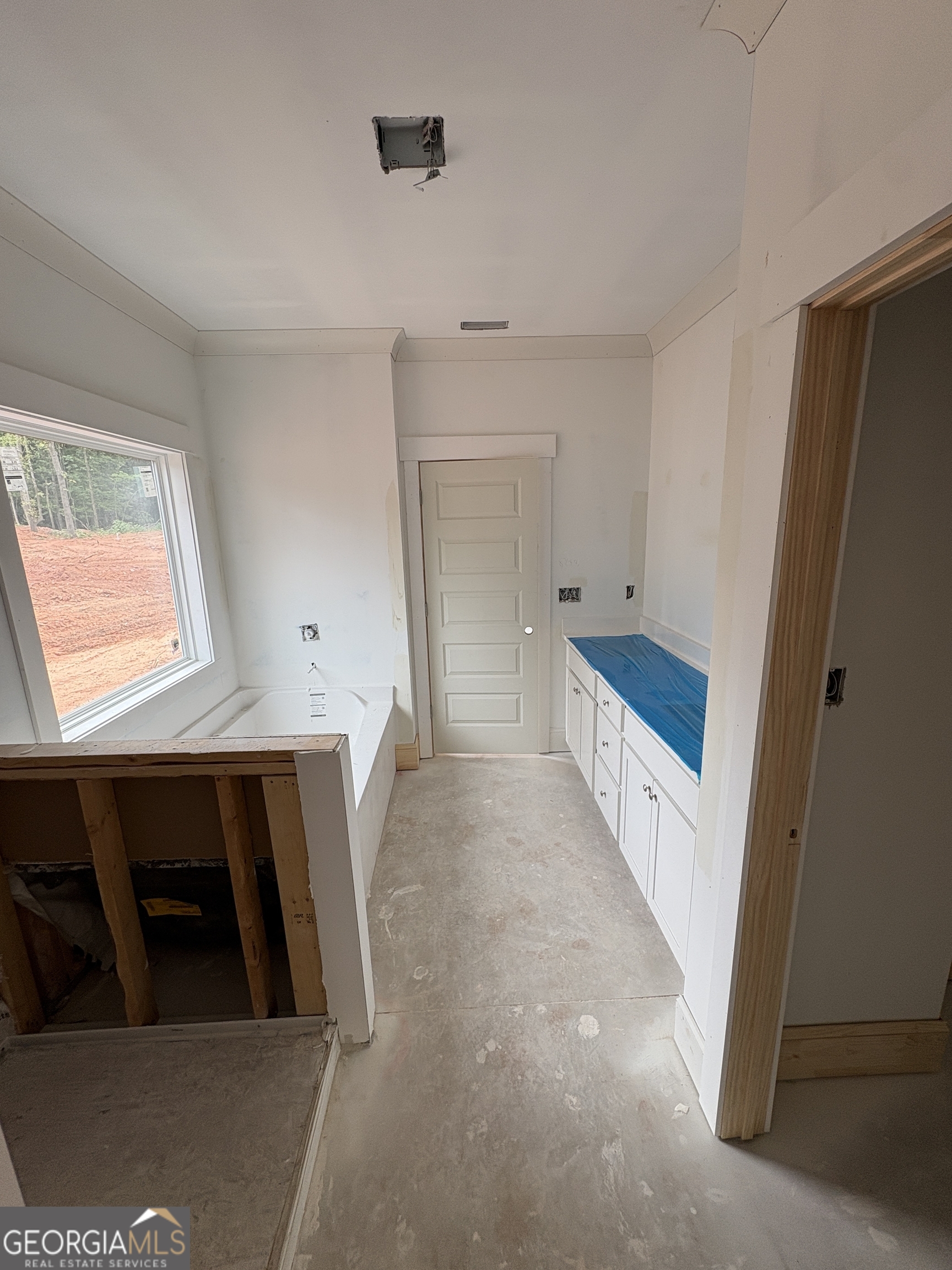 1903 Hoods Mill Road Jefferson, GA 30549 - Photo 6 of 6 a view of an empty room with wooden floor and a window