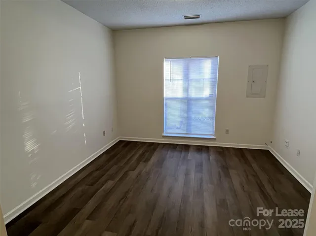 a view of a room with wooden floor and window