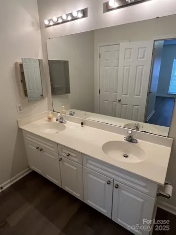 a bathroom with a double vanity sink and mirror